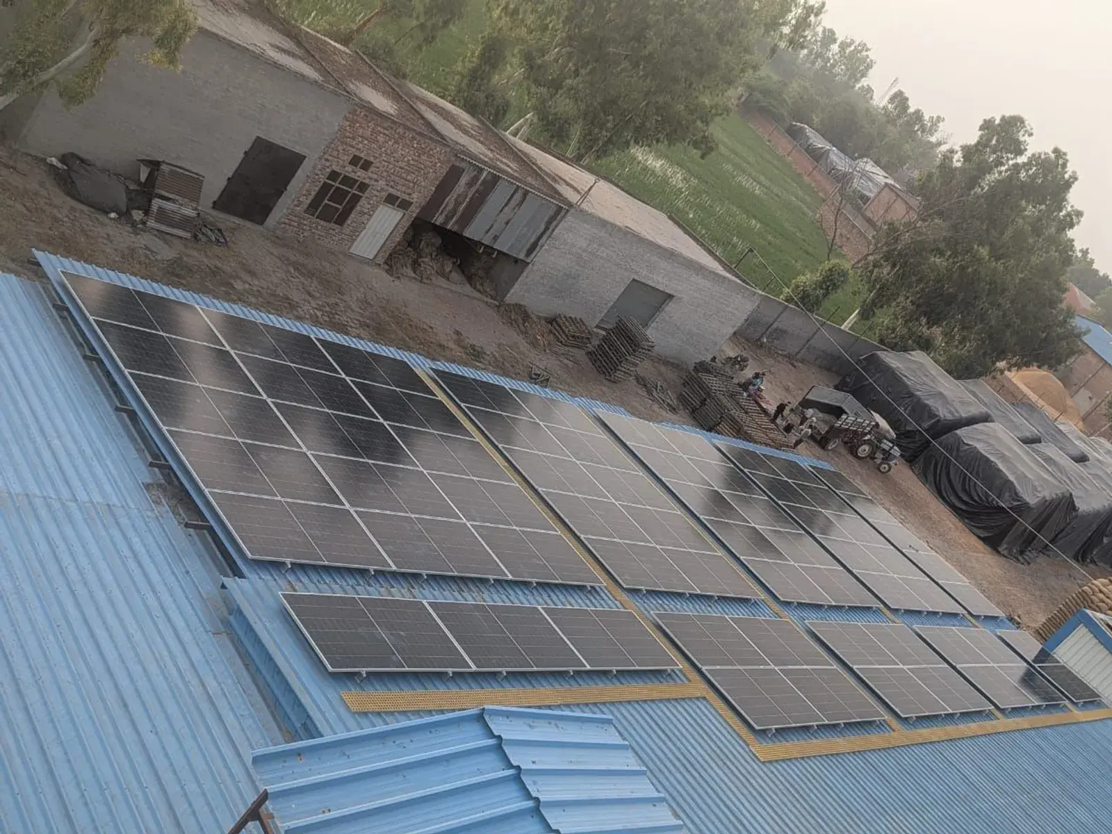 Aerial view of Avaada TOPCon modules across the tin-shed rooftop
